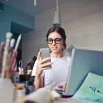 Photo by Andrea Piacquadio: https://www.pexels.com/photo/woman-in-white-t-shirt-holding-smartphone-in-front-of-laptop-914931/