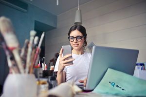 Photo by Andrea Piacquadio: https://www.pexels.com/photo/woman-in-white-t-shirt-holding-smartphone-in-front-of-laptop-914931/